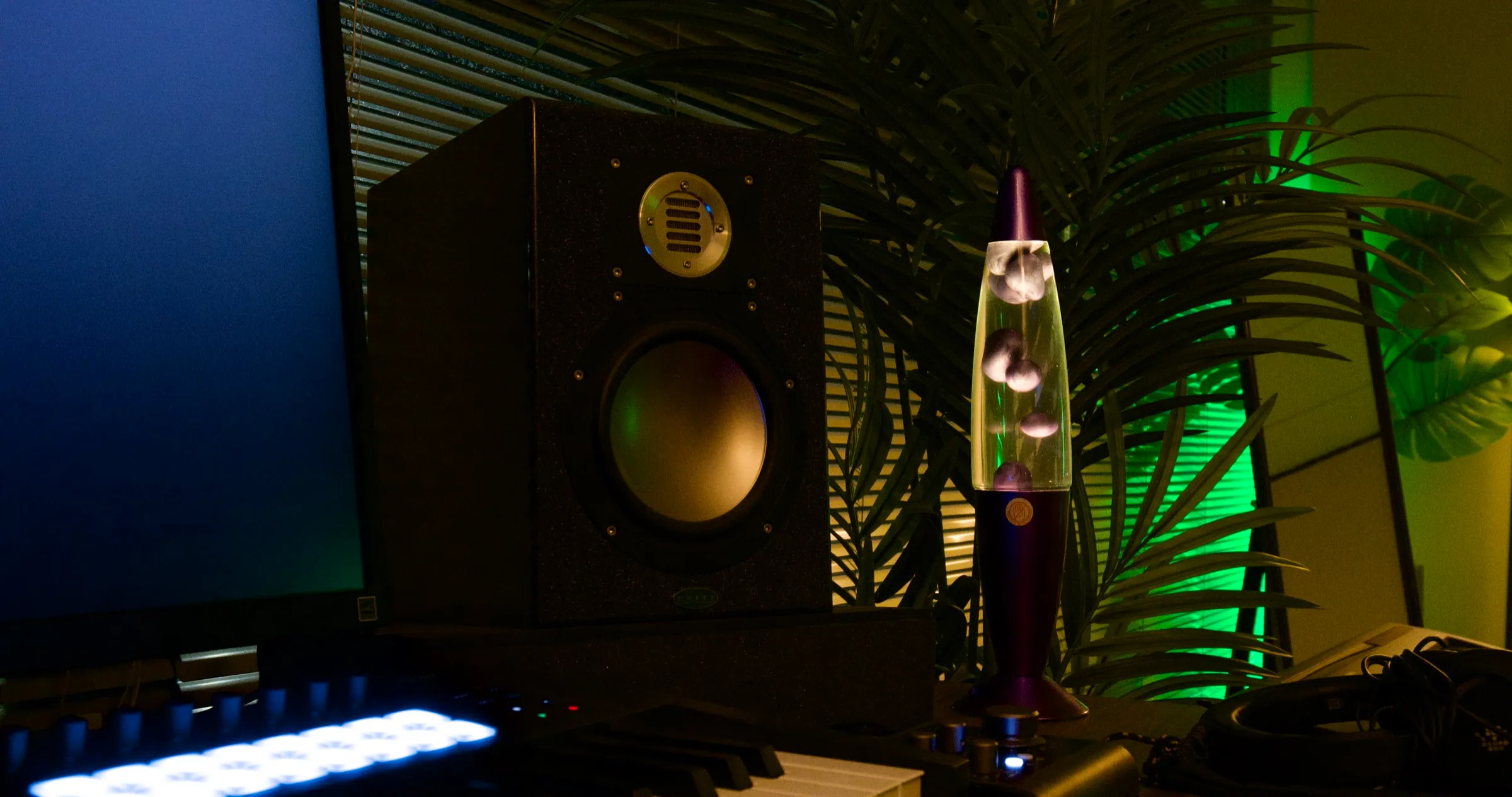 Studio 4 at Kiln - the writing desk, monitors and keys in warm lamp light